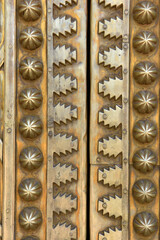 Brass doors adorned with Moroccan patterns, metal filigree, and intricate relief work. Royal Palace, Fez, Morocco