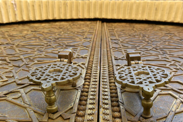 Brass doors adorned with Moroccan patterns, metal filigree, and intricate relief work. Royal Palace, Fez, Morocco