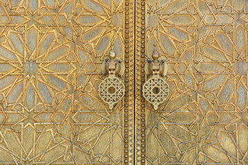 Brass doors adorned with Moroccan patterns, metal filigree, and intricate relief work. Royal Palace, Fez, Morocco