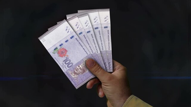 Malaysia Ringgit money fan of banknotes in hand 4k video