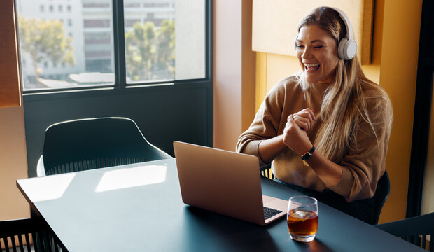 Young woman enjoying a remote online meeting in a bright modern office - Powered by Adobe