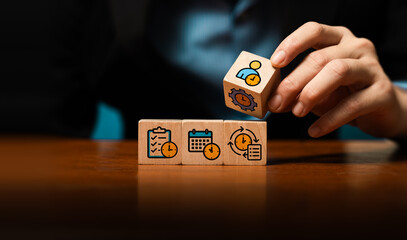 Time management concept with business hand stacking wooden blocks showing clock, calendar, checklist and workflow icons, symbolizing productivity, efficiency, task planning, effective organization