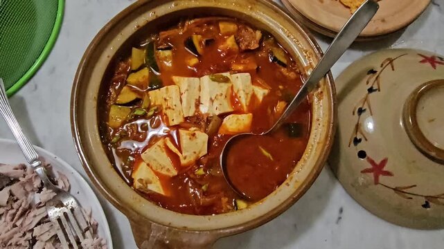 pot of honey,,Kimchi jjigae or Kimchi soup in ceramic bowl
Korean kimchi stew.Korean traditional food,Sundubu jjigae