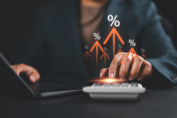 Interest rate concept, Businessman using calculator with graph percentage symbol and up arrow, Growth of investments and profits, Dividends and long term investing to win Inflation, calculate taxes.