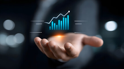 Naklejka premium A person's hand displays a holographic chart and graph showing data analytics and financial growth metrics.