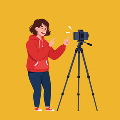 Person in red hoodie films with camera on tripod
