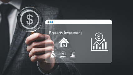 Fototapeta premium Businessman with magnifying glass analyzing property investment growth and financial strategy concept.