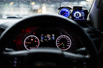 Digital and analog speedometer of racing cars,A close up of a speedometer inside a car, showing the speed dial reaching high numbers as the vehicle accelerates.