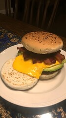 Delicious bacon avocado burger with melted cheese served on a plate