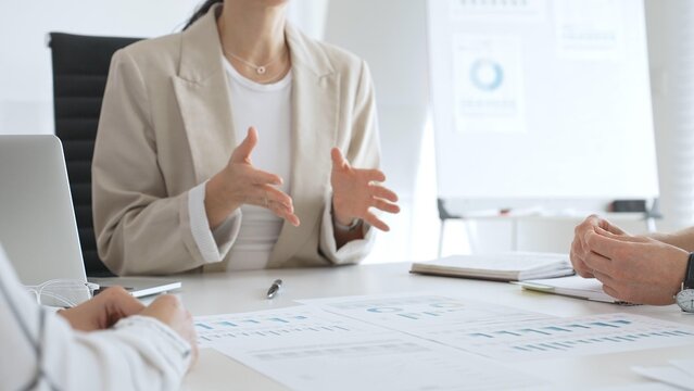 Business people team discussing financial data and analyzing charts during a productive meeting in the office, focusing on collaborative teamwork and strategic decision making