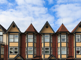 Beautiful vintage stile architecture with charming gables under a blue sky in an urban setting during daytime hours