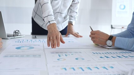 Business team analyzing financial charts and graphs during corporate meeting, focusing on strategy development, data driven decision making, growth and planning