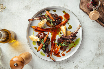 Juicy lamb chops served with roasted carrots, fried cheese and herb sauce