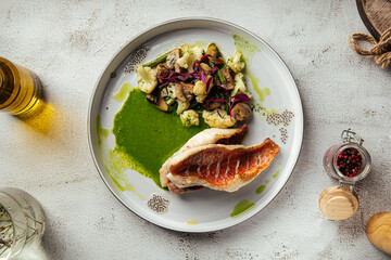 Elegant plate with grilled sea bass, mushrooms, and puree