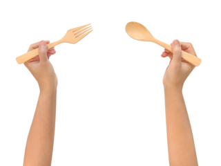 Top view woman's hands holding a wooden spoon and fork, waiting to eat isolated on white background