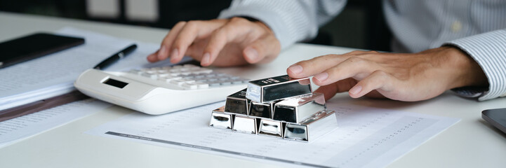 Businessman reviews silver market charts for investment opportunities