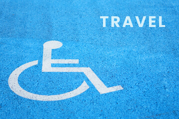 disability and travel concept. word “travel” written next to a wheelchair symbol