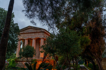 Neoclassical Garden Monument at Dusk Framed by Trees