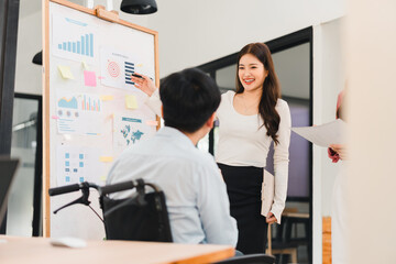 Young businesswoman presenting marketing charts smiling and engaging colleagues