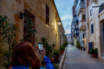 Evening Alley Photography with Traditional Balconies and Warm Streetlights