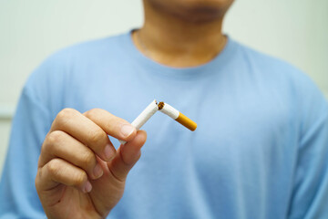 Quit smoking, Asian man breaking destroy cigarette in hand.