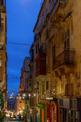 Blue-Hour Stepped Street with Festoon Lights and Weathered Limestone Facades