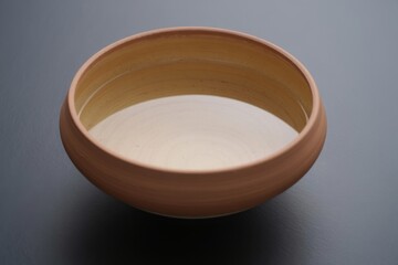 Simple wooden bowl filled with light colored liquid