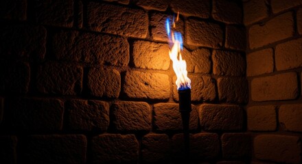 Naklejka premium Flaming Torch Burning on Brick Wall in Dark Environment