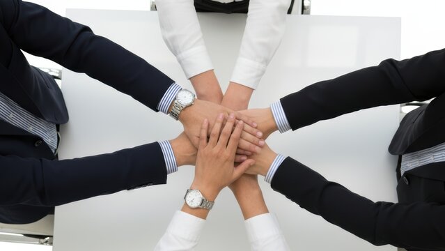 Business team stacking hands signifying unity collaboration and support in achieving shared goals together for success