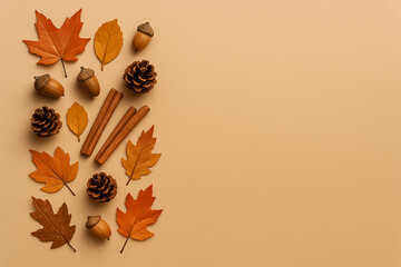 Flat Lay Autumn Background with Leaves, Acorns, Pine Cones, and Cinnamon on Beige