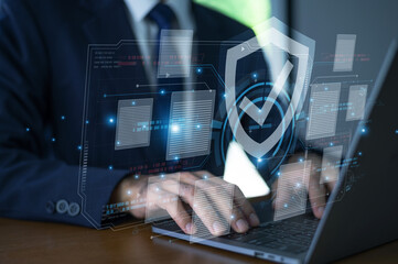 Businessman use laptop data security to manage sensitive company files through encrypted cloud storage, ensuring privacy and compliance with global cybersecurity standards.