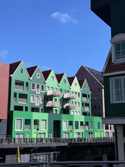 Colorful green gabled houses in modern Dutch architecture under blue sky
