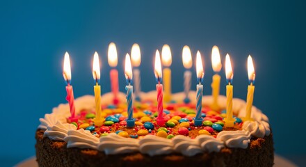 Birthday cake with lit candles and sprinkles