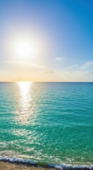 Fototapeta premium Bright sun glints across tranquil ocean waters, illuminating turquoise and blue tones of the sea beneath a clear, vibrant sky with subtle cloud formations, evoking feelings of peace and serenity...