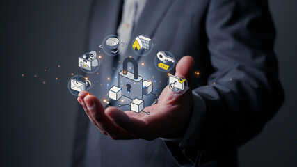 Businessman holding a padlock icon protecting business data. Cybersecurity, data protection, and digital security technology concepts.