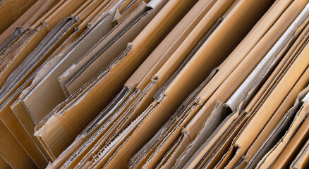cardboard box, stack of folded corrugated cardboard boxes neatly arranged, brown packaging carton box, representing recycling, packaging, eco, and sustainable resource use