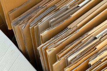 cardboard box, stack of folded corrugated cardboard boxes neatly arranged, brown packaging carton box, representing recycling, packaging, eco, and sustainable resource use