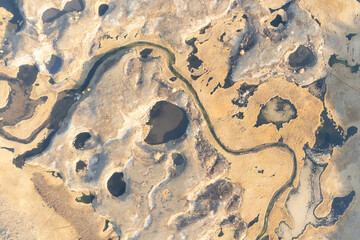 Craters filled with water and a winding river ,from above.