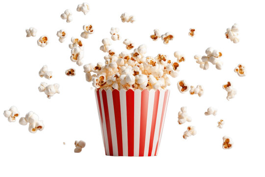 Popcorn overflows from a red and white striped container against a creating a fun snack scene on transparent background
