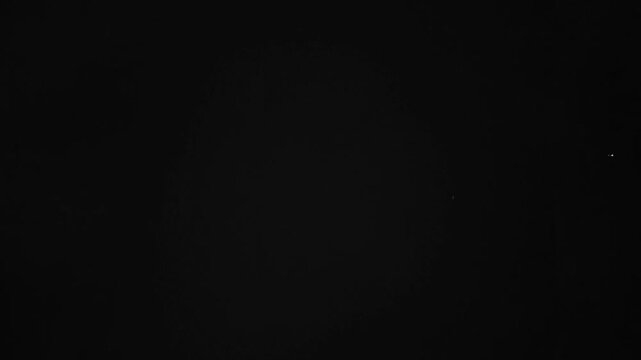 Solid black background with subtle textured grid image