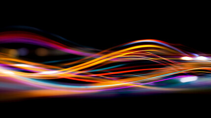 Abstract light trails with vibrant colors on a dark black background