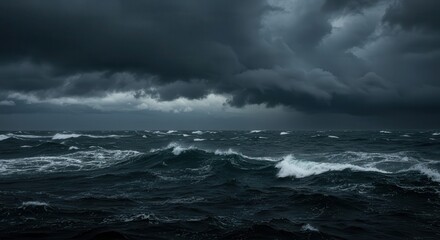 Fototapeta premium Overcast skies loom above a turbulent ocean, with ominous dark clouds covering the horizon, casting a moody atmosphere over churning waves under a stormy sky.