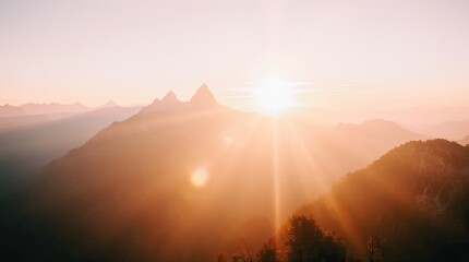 Sunrise over Mountain Peaks with Lens Flare