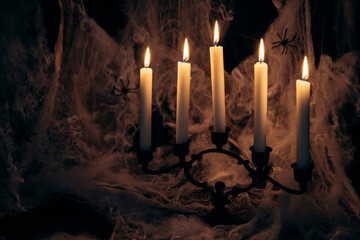 Halloween composition with candles on black grunge background