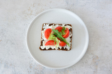 Delicious Open-Faced Sandwich with Fresh Tomatoes, cream cheese and Greens