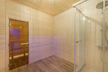 The interior of the spa center room. The glass door to the sauna. Shower cabin.