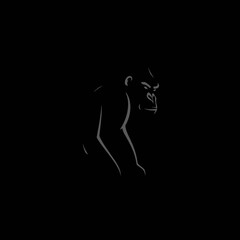 Silhouette of a gorilla in dark tones, with the animal's outline highlighted against a black background.