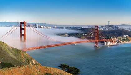 golden gate and the san francisco bay covered by fog the financial district skyline in the background as seen from the marin headlands state park california © Cristina