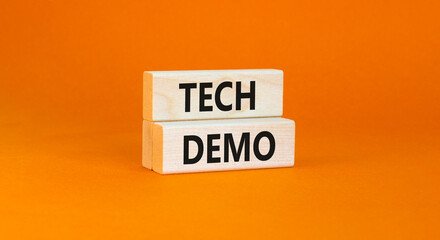 Tech demo symbol. Concept word Tech demo on beautiful wooden blocks. Beautiful orange paper background. Business tech demo concept. Copy space.