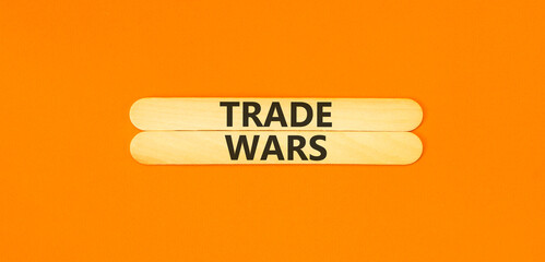 Trade wars symbol. Concept word Trade wars on beautiful wooden sticks. Beautiful orange paper...